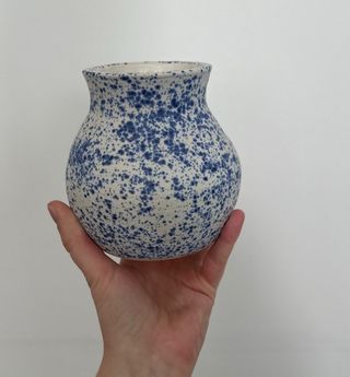 A speckled cobalt-and-cream vase, handmade by Mae